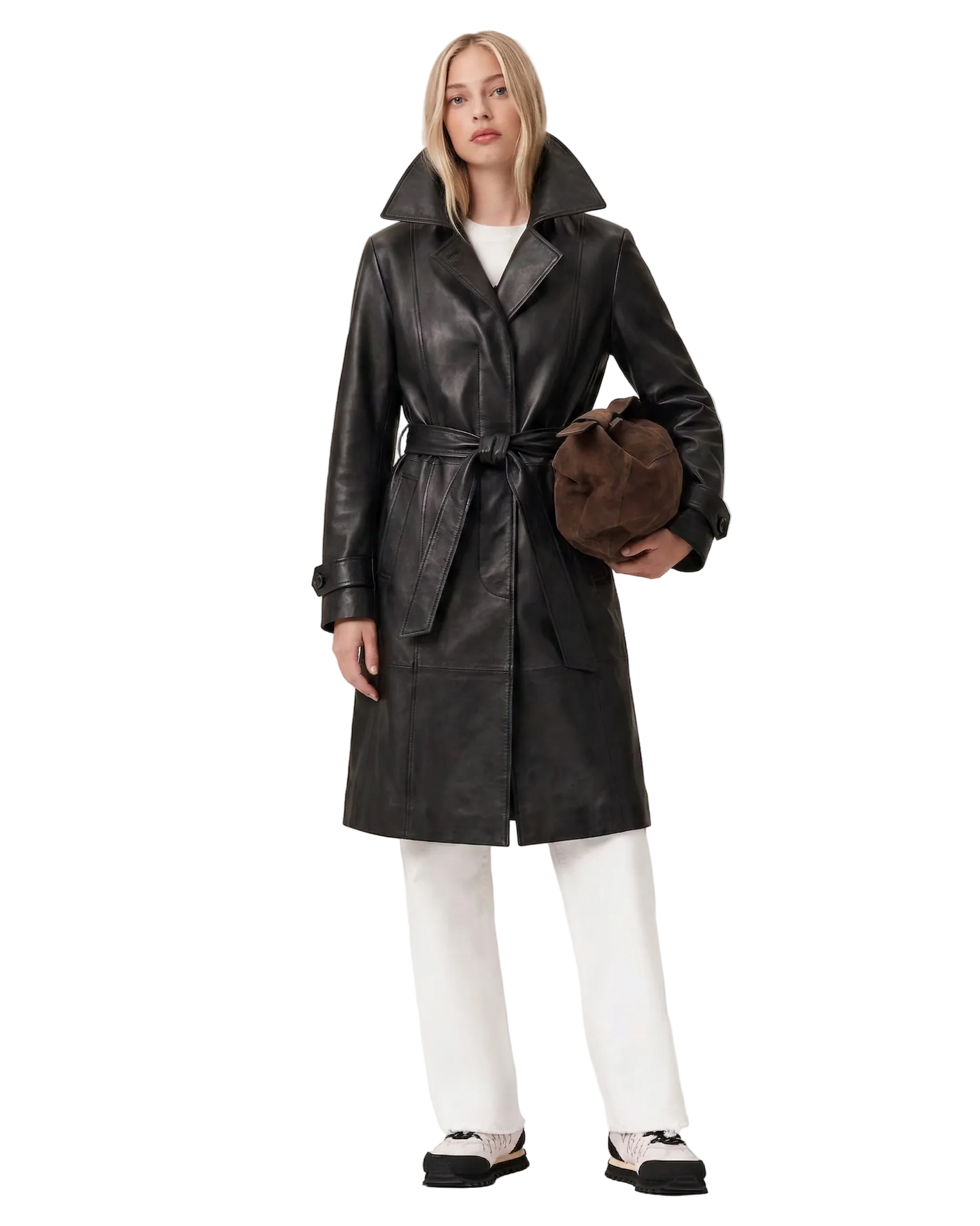 Black leather trench coat with belt, paired with white pants and sneakers, holding a brown bag