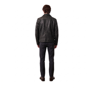 Man wearing black leather jacket and dark jeans, back view