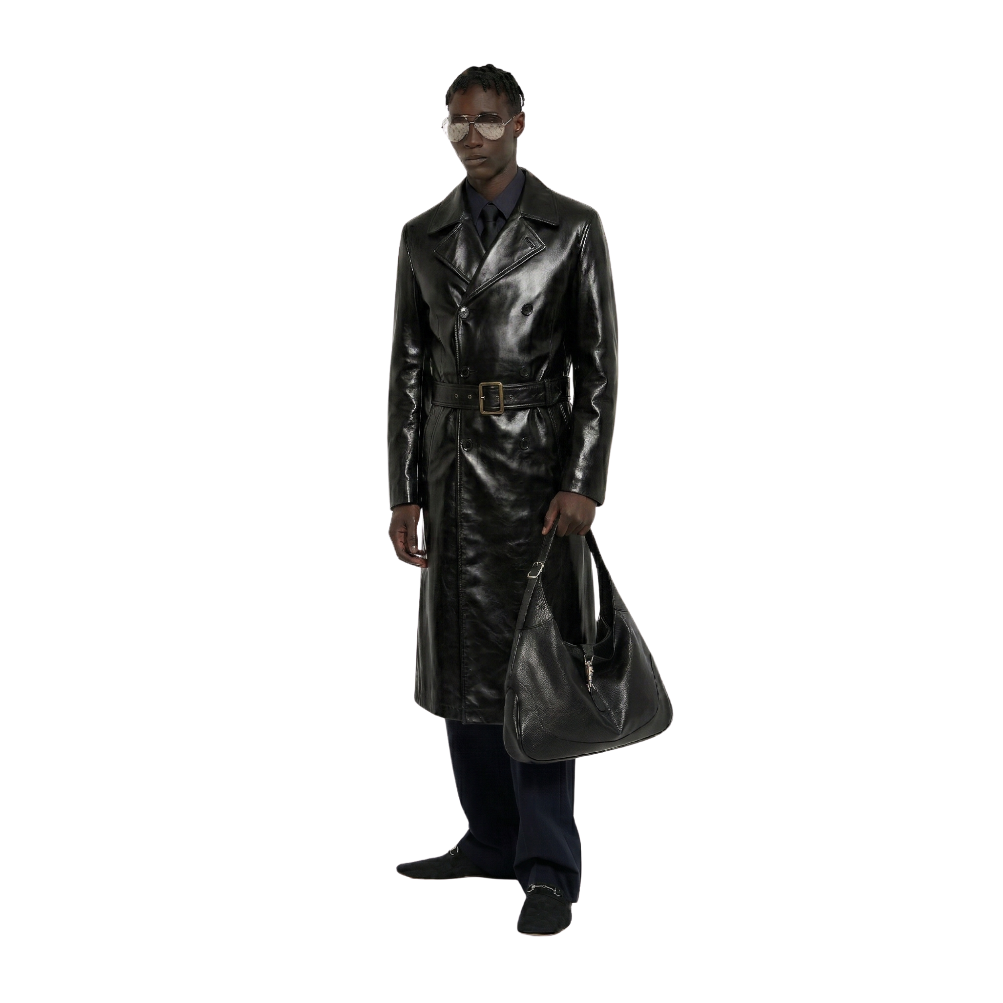 Man in sleek black leather trench coat with belt, holding matching bag, stylish urban look