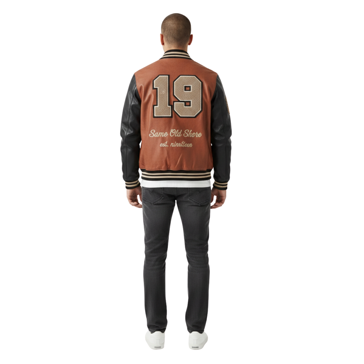 Man wearing a brown and black varsity jacket with number 19 on the back, standing against a white background.