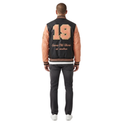 Men's varsity jacket with '19 Same Old Shore' back print, black body, peach sleeves, striped cuffs