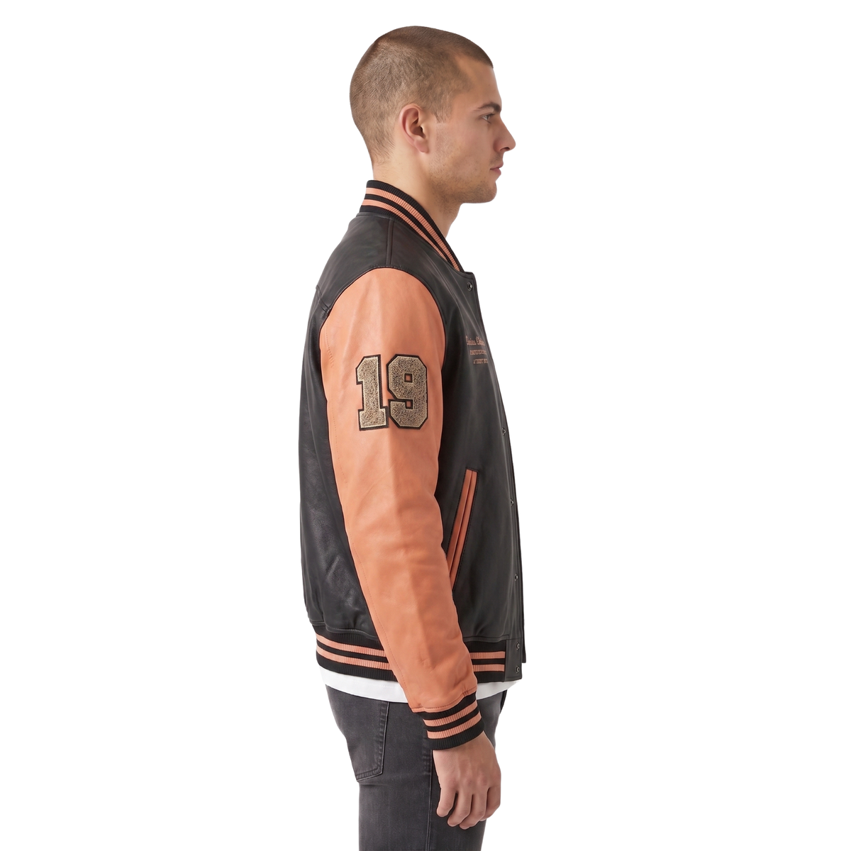 Man wearing a black and orange varsity jacket with number 19 on a white background