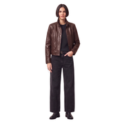 Woman wearing brown leather jacket, black jeans, and boots for stylish casual outfit