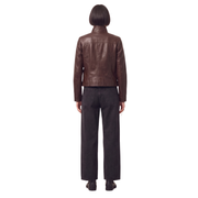 Brown leather jacket with black wide-leg jeans, back view