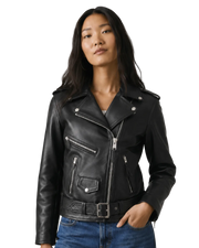 Woman wearing black leather biker jacket with zippers and belt, paired with blue jeans