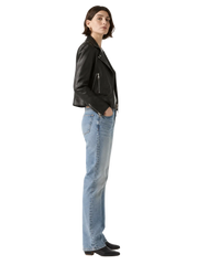 Woman in black leather jacket and light blue jeans, stylish casual outfit