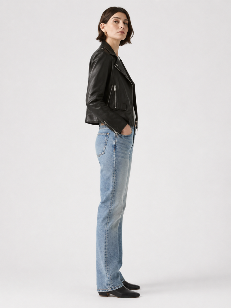 Woman in black leather jacket and light blue jeans, stylish casual outfit
