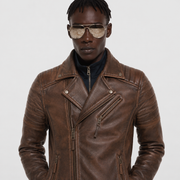 Men's brown leather biker jacket with zippers and snap buttons, styled with aviator sunglasses