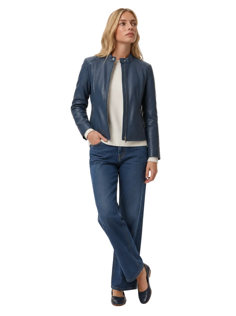 Woman styling a women's tailored leather collarless jacket in a rich steel blue color, styled open over a white ribbed knit sweater.