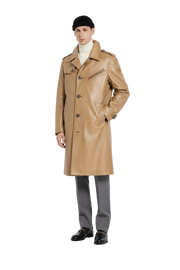 Tan leather trench coat for men, styled with turtleneck, gray trousers, and black loafers