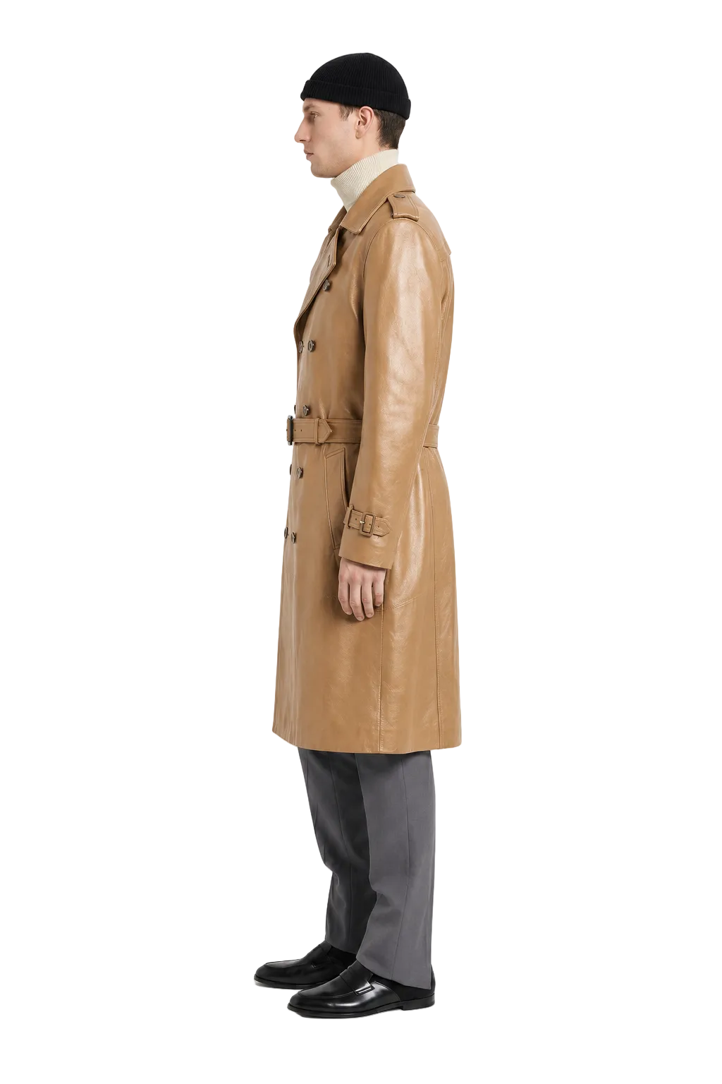 Men's tan leather trench coat with belt, worn with beanie and gray trousers