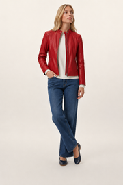 Woman wearing red leather jacket, white sweater, and blue wide-leg jeans