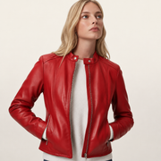 Red leather moto jacket with zipper details, worn over white sweater