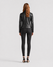 Woman wearing black leather jacket and skinny jeans, back view