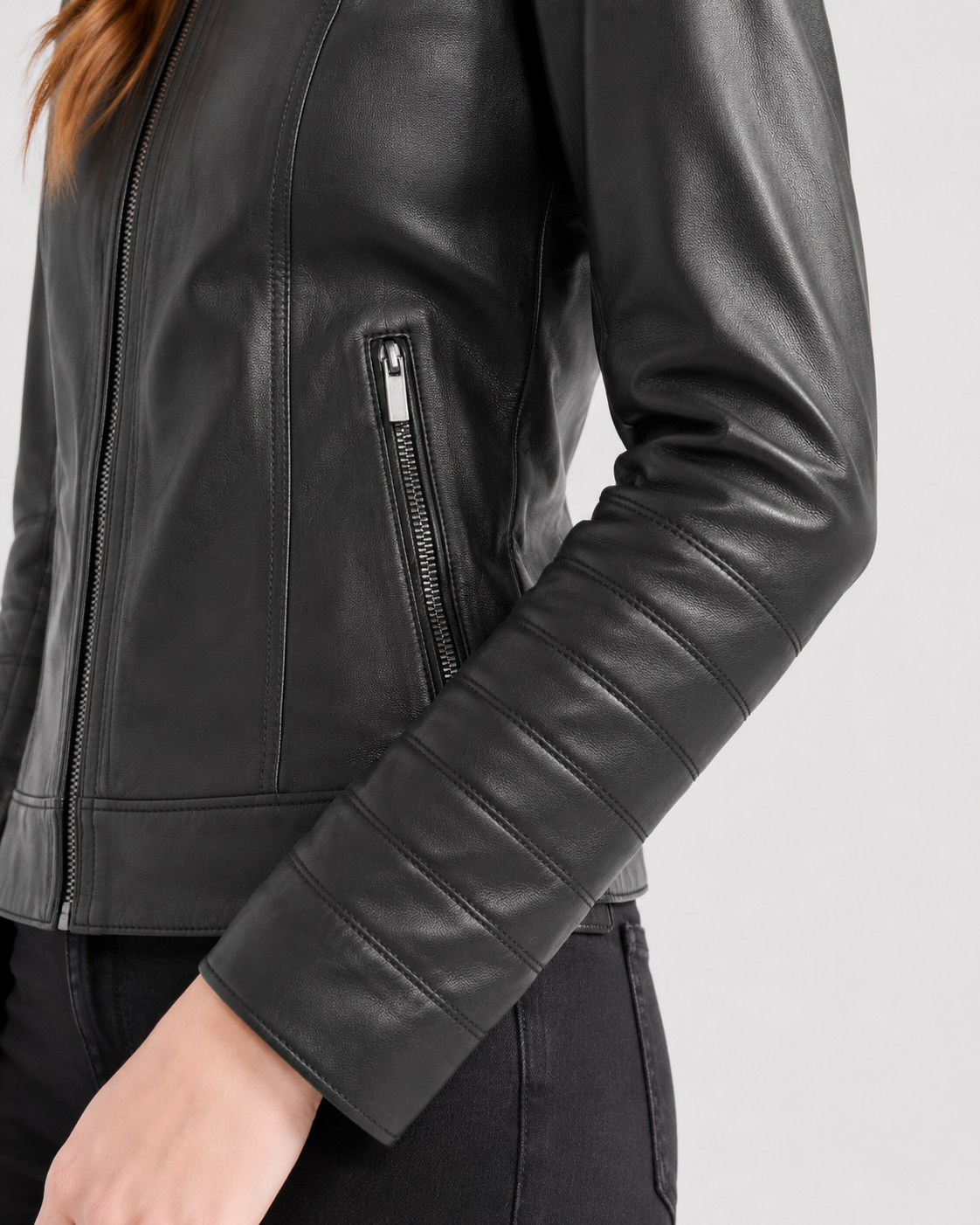 Black leather moto jacket with zipper pocket and ribbed sleeve detail