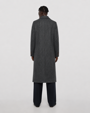 Men's charcoal gray textured overcoat with notched lapel, back view, paired with dark trousers