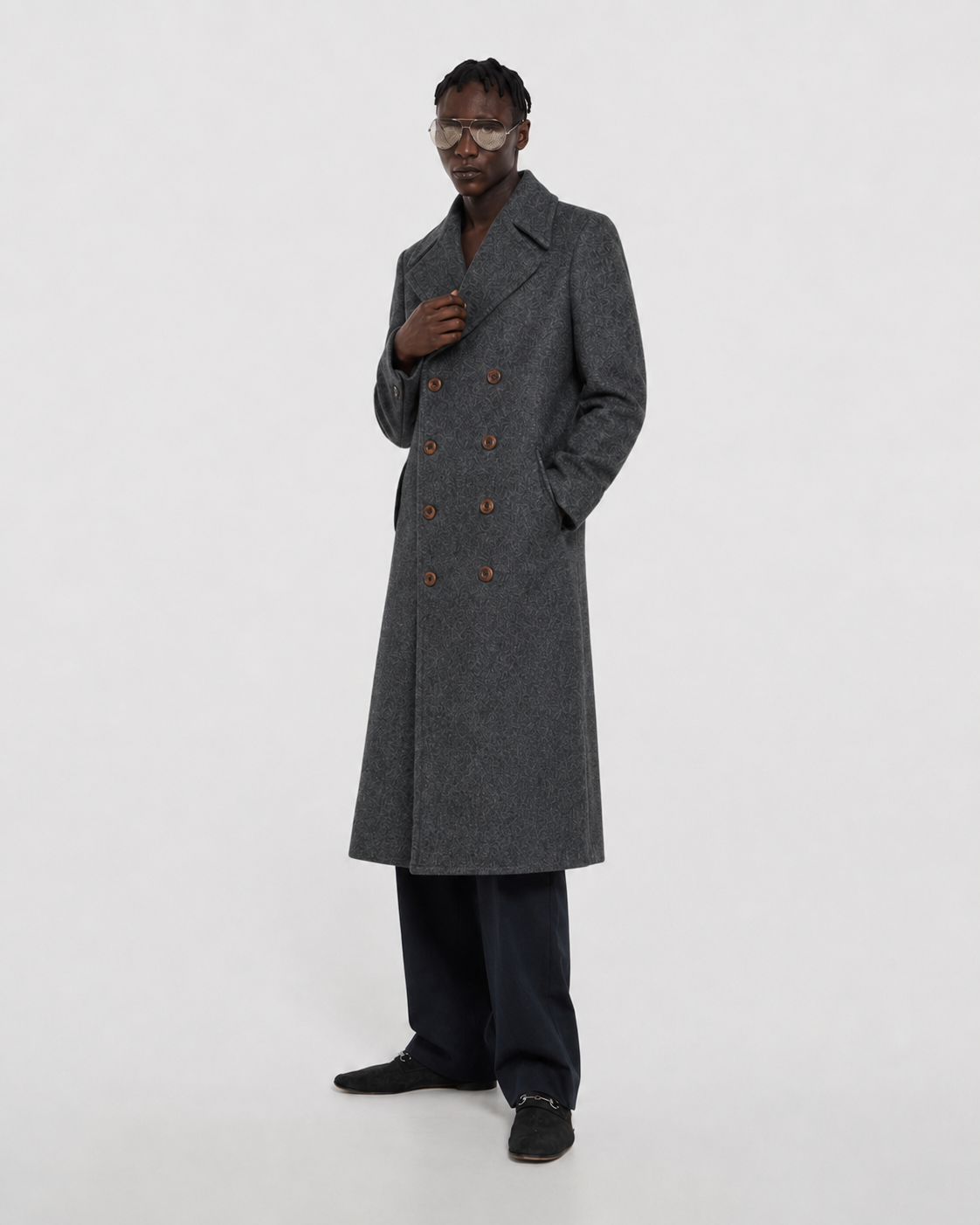 Men's gray double-breasted long coat with patterned wool blend, styled with dark trousers and loafers