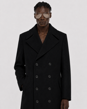 Men's black double-breasted wool coat with wide lapels and six-button front, styled with aviator sunglasses.