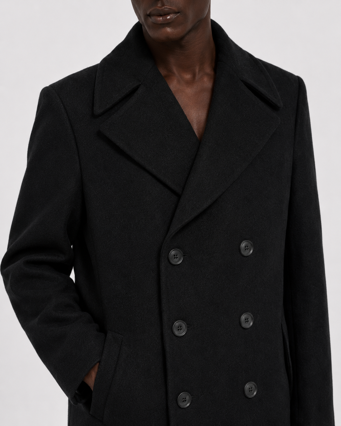 Black double-breasted wool coat with notched lapel and front pockets