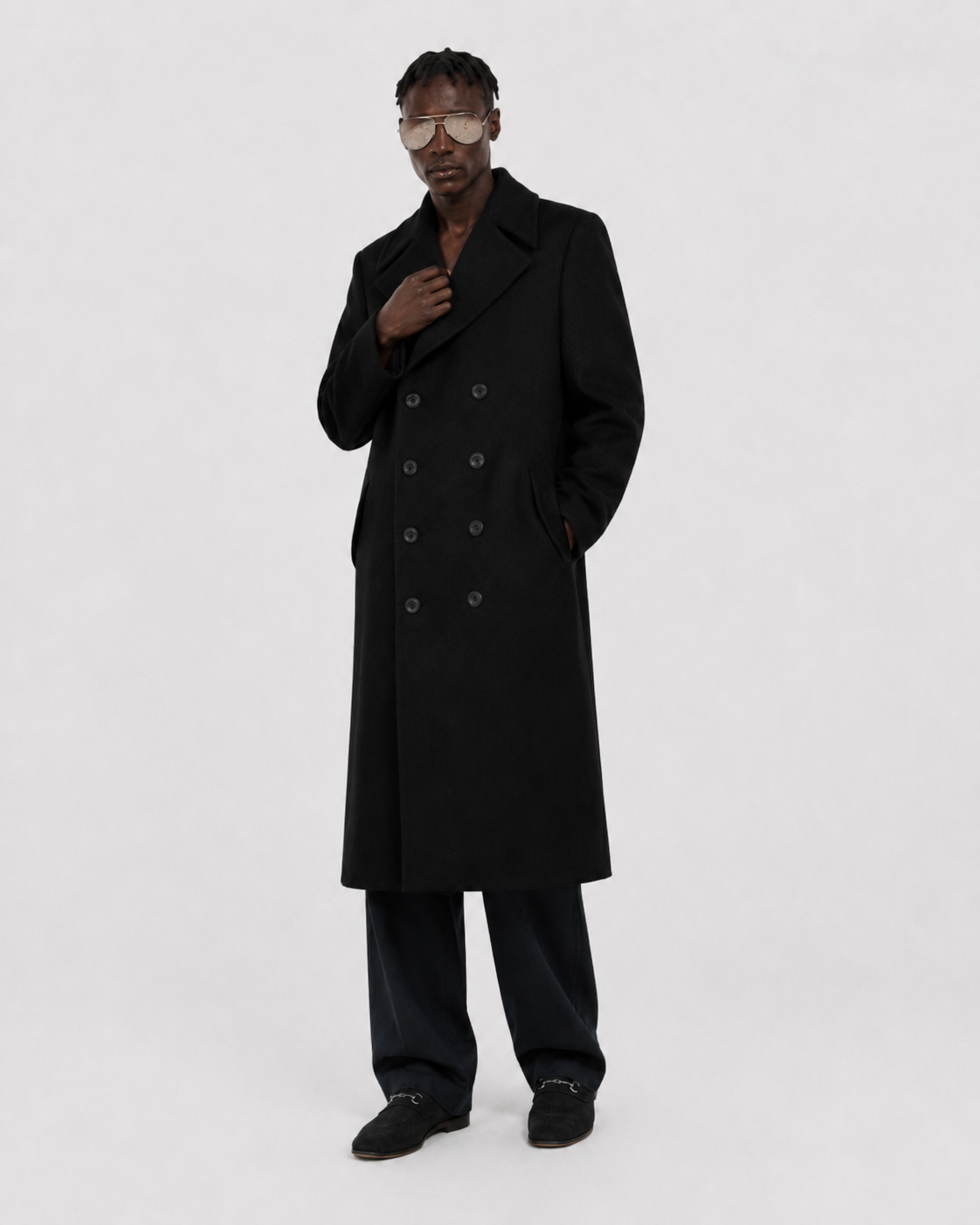 Man wearing black double-breasted long coat with sunglasses, stylish winter outerwear