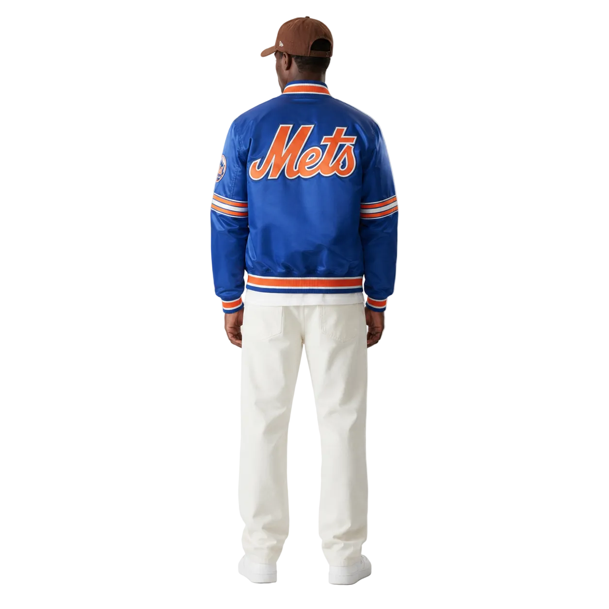 Blue Mets varsity jacket with orange lettering, worn by man in white pants and cap, back view