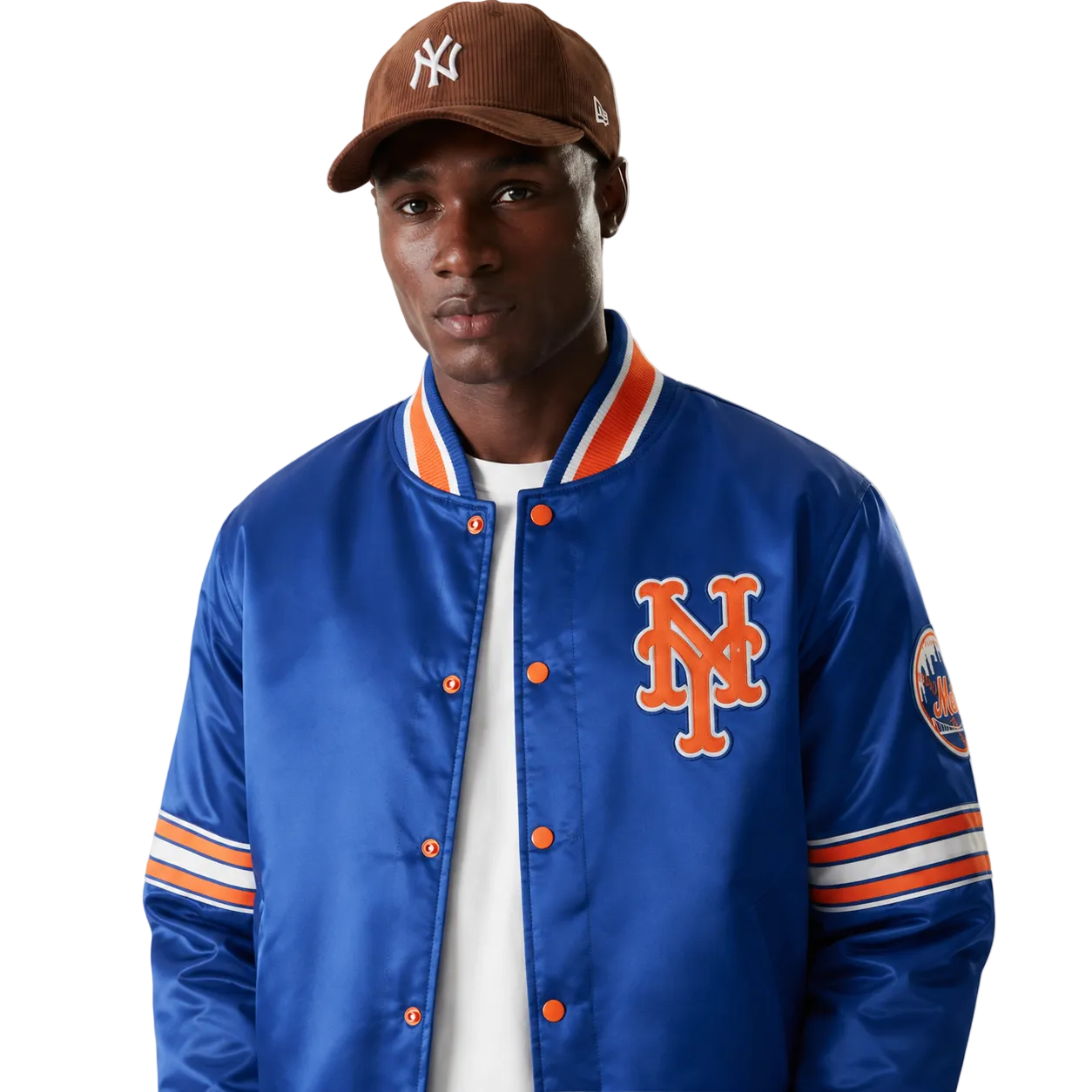Blue New York Mets satin varsity jacket with orange logo and striped sleeves, worn with brown cap