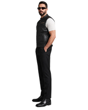 Man wearing black leather vest, sunglasses, and slim-fit pants for a stylish biker look