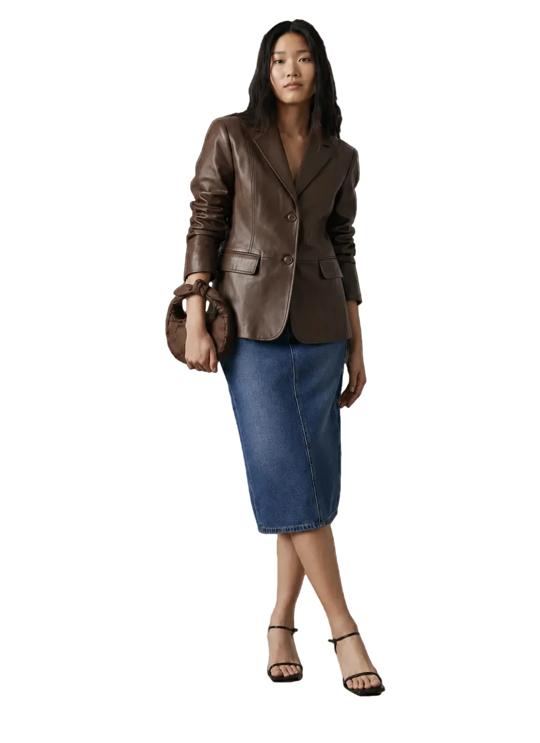 Woman in brown leather blazer, denim midi skirt, black heels, and matching handbag, studio fashion look