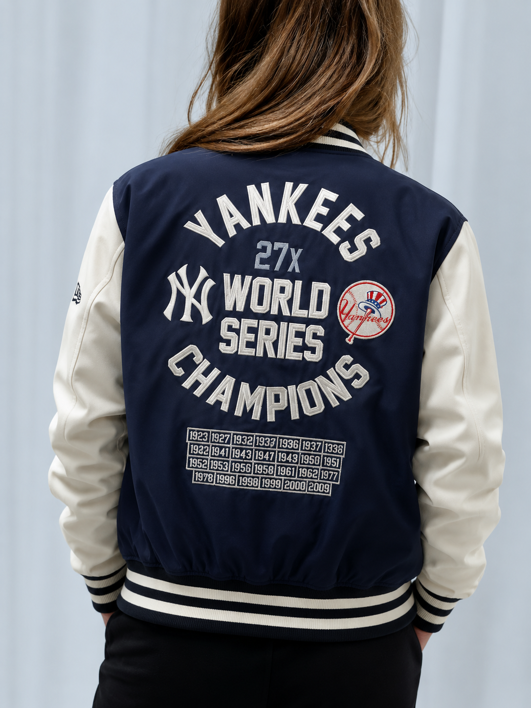 Yankees 27x World Series Champions varsity jacket with championship years, navy and cream design