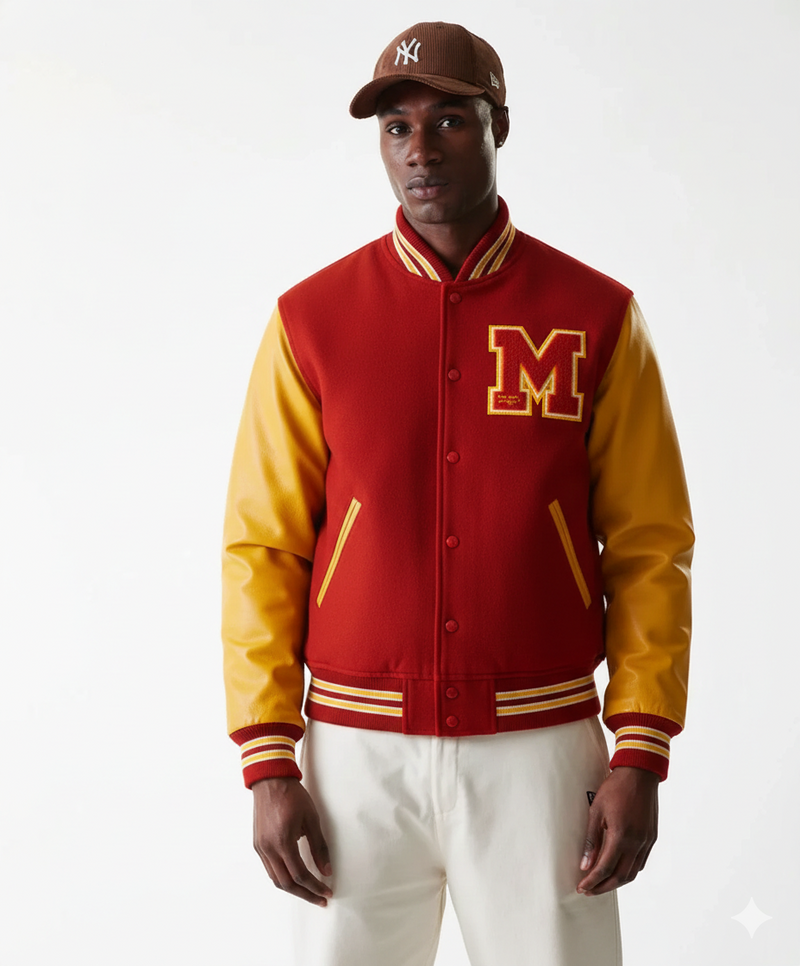 Red and gold varsity jacket with embroidered M, worn with brown cap and white pants