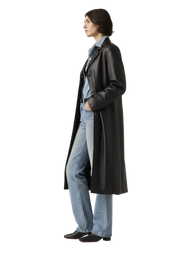 Woman in black leather coat, blue jeans, and black boots, side profile