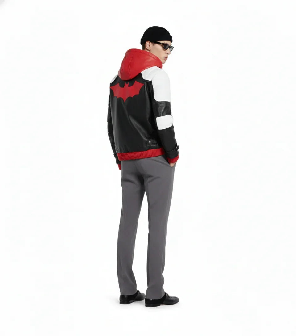 Men's black leather jacket with red bat logo, white panels, and hood, styled with gray pants and beanie
