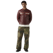 Man wearing burgundy Harley-Davidson leather moto jacket with camo cargo pants