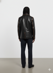 Black leather jacket with contrast stitching, back view on model wearing dark trousers