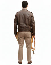 Man wearing brown leather jacket, beige pants, holding rope, back view