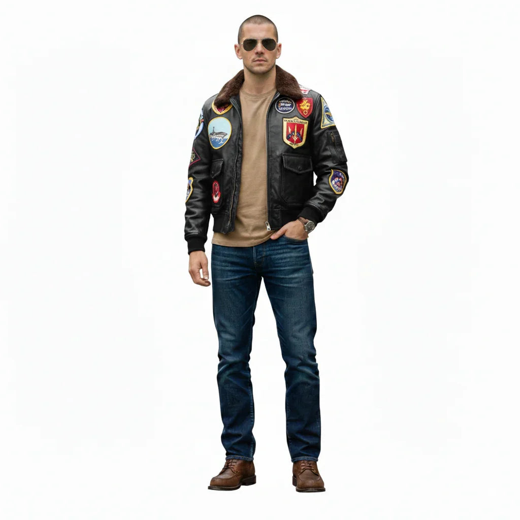 Man wearing black leather bomber jacket with patches, jeans, and aviator sunglasses