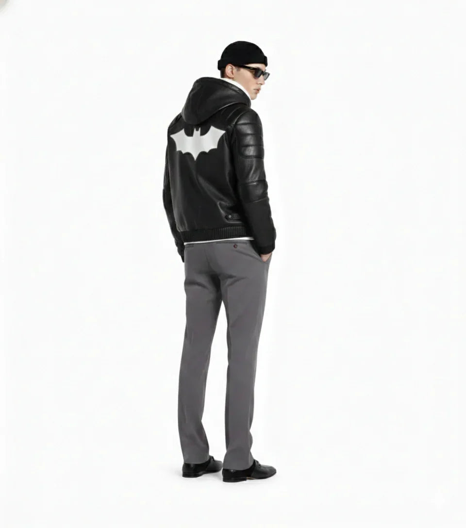 Men's black leather jacket with white bat emblem, styled with gray pants and beanie