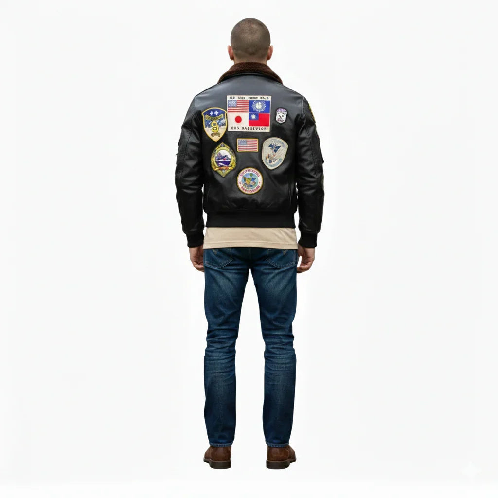 Men's black leather bomber jacket with vintage aviation patches, shearling collar, and classic fit