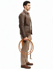 Man in brown leather jacket holding coiled rope, side profile, casual outdoor style