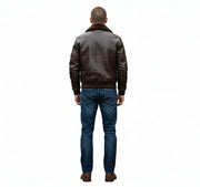 Men's brown leather bomber jacket with shearling collar, back view, paired with blue jeans
