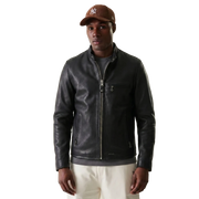 Men's black leather jacket with front zipper and side pockets, styled with cap and casual pants