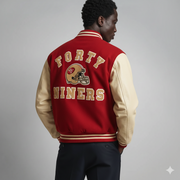 Red and gold San Francisco 49ers varsity jacket with helmet logo, worn by man in studio