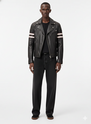 Men's black leather biker jacket with striped sleeves, paired with dark jeans and casual shoes