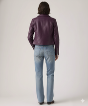 Purple leather moto jacket with zipper details, paired with light wash denim jeans, back view
