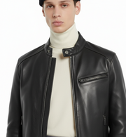 Men's black leather biker jacket with zipper details over cream turtleneck, stylish casual outerwear