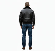 Men's black leather bomber jacket with shearling collar, back view, paired with blue jeans