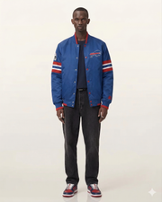 Blue Buffalo Bills varsity jacket with red and white stripes, worn with dark jeans and sneakers