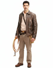Man in vintage brown leather jacket, beige shirt, and khaki pants holding coiled rope, rugged outdoor style