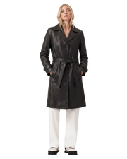 Black leather trench coat with belt, paired with white pants and sneakers