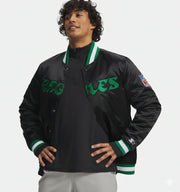 Men's black Eagles varsity jacket with green lettering and NFL patch, featuring ribbed collar and cuffs